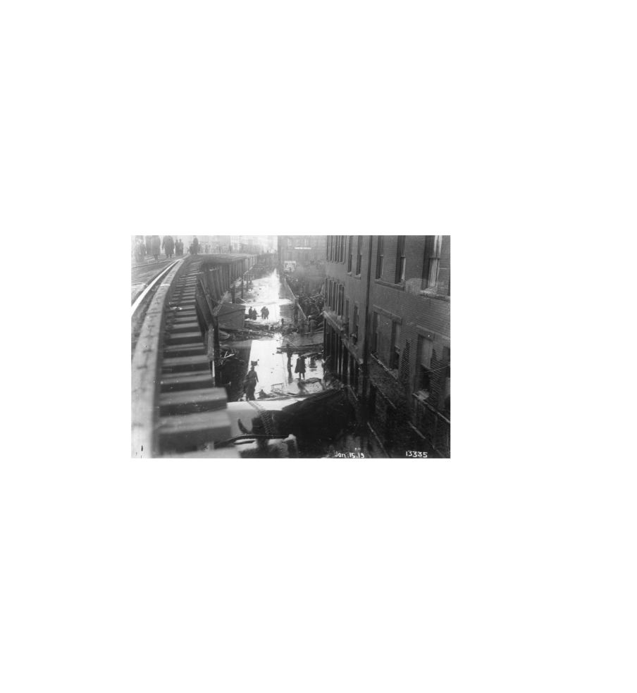 Aerial view of Boston's Commercial Street flooded with molasses beside the wrecked elevated railway after the Great Molasses Flood, January 1919.